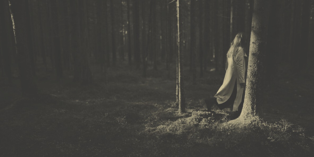 A woman walking through the forest